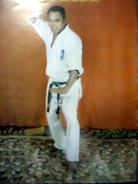 A karateka holding a stance, photographed from the side.